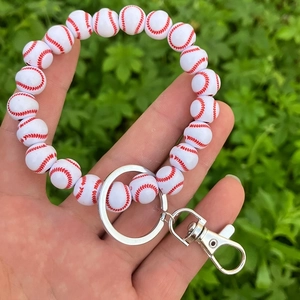 Detailed close-up of a white wooden baseball bead bracelet keychain with metal clasp