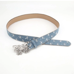 Denim blue canvas belt with silver butterfly buckle and beaded details on white background