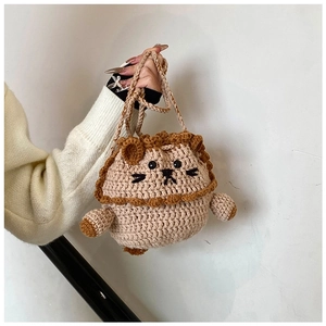 Close-up of handmade crochet lion drawstring bag showing detailed yarn texture and knit