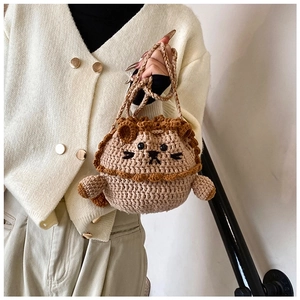Detailed macro view of the handmade crochet lion drawstring bag with brown mane textures