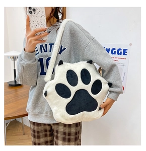 Close-up of plush cat paw crossbody bag showing soft texture and shoulder strap