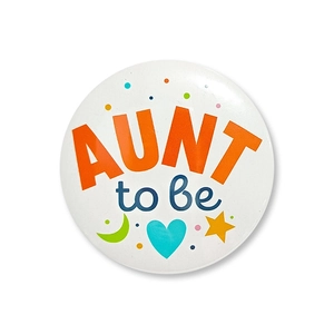 Close-up of Aunt to Be tinplate badge for baby shower and gender reveal parties