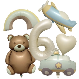 Detailed set of matte bear, number 6, airplane, and rainbow foil balloons for party decor