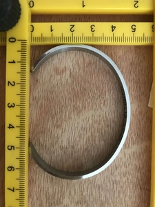 Detail showing Best Bitches engraving inside a 6mm stainless steel open cuff bracelet