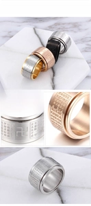 Macro detail of rotating stainless steel Buddhist ring with engraved Heart Sutra