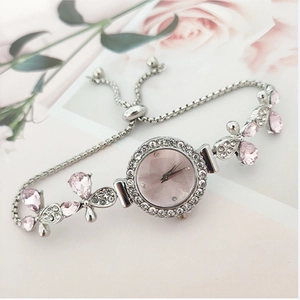 Detailed view of silver flower bracelet watch with pink dial and adjustable slider clasp