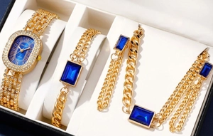 Close-up of golden jewelry set with blue rectangular gems and a diamond-inset quartz watch