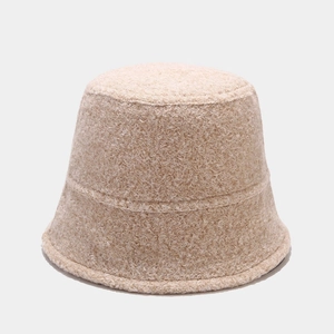 Close-up of the textured beige sherpa bucket hat showing thick warm fleece material