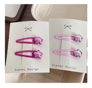 Close-up of pink star-shaped hair clips for girls on display cards set of four