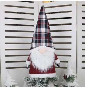 Detail of a Christmas gnome with black and white plaid hat and long white beard