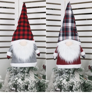 Detail of Christmas gnome tree toppers with red and grey plaid hats and long white beards