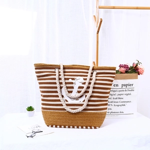 Striped canvas beach tote bag with rope handles and anchor logo for summer travel
