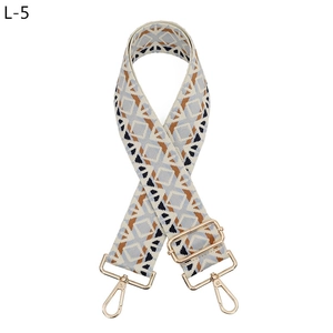Detail of adjustable geometric diamond pattern bag strap with gold metal lobster hooks