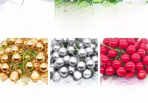 Close-up of metallic gold, silver and red Christmas berry picks with wire stems