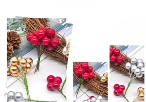 Detailed view of red, gold and silver artificial Christmas berries for festive wreaths