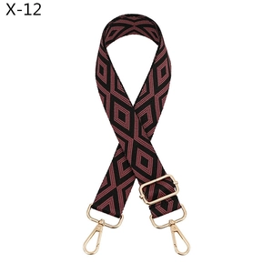 Close-up of adjustable wide jacquard strap with red and black geometric diamond pattern