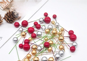 Close-up of shiny red, gold and silver Christmas foam berries with flexible wire stems