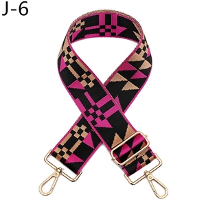 Detail of adjustable geometric houndstooth bag strap with gold metal swivel hooks
