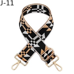 Detail of bohemian geometric woven bag strap with golden metal hooks and adjustable buckle