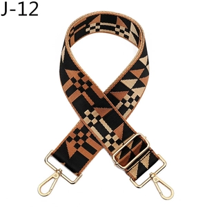 Detail of adjustable geometric woven bag strap with golden metal swivels and leather ends