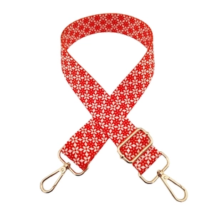 Adjustable red floral shoulder strap with white flower patterns and golden metal buckles