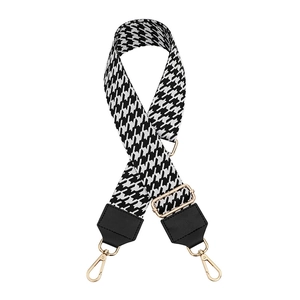Adjustable black and white houndstooth wide shoulder strap with gold metal buckle
