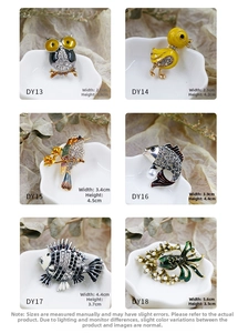 Detail view of colorful owl and bird enamel brooches with rhinestones and pearls