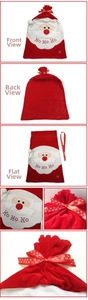Detail view of red velvet Santa gift bag with Ho Ho Ho embroidery and white pom-poms
