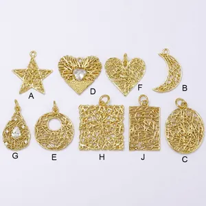 Detailed view of nine assorted brass wire-wrapped hollow star and moon pendants