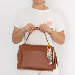 Classic brown PU leather handbag featuring a vibrant colorful acrylic chain tassel keychain
