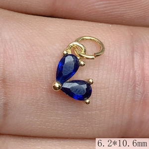 Detail shot of a small gold-plated blue zircon heart pendant measuring 6.2mm by 10.6mm