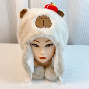 Detail of soft plush Capybara hat with cute bear ears and decorative fluffy grey pompoms