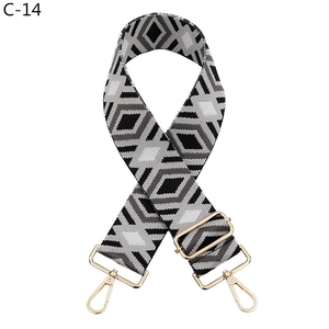 Detail of adjustable wide shoulder strap with black, white, and grey diamond pattern