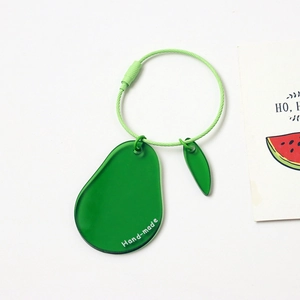 Detailed macro view of a handmade avocado acrylic keychain with green wire loop ring