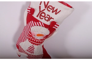 Detailed close-up of large Christmas stocking with snowman design and New Year embroidery