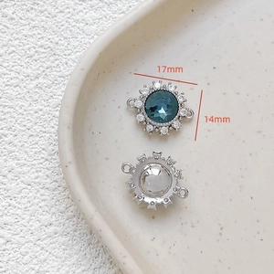 Macro detail of 18k gold plated sunburst pendant with blue zircon, size 17mm x 14mm