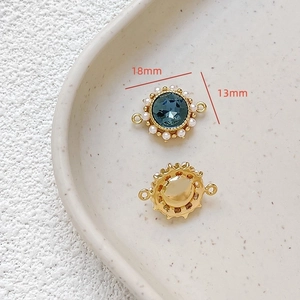 Detailed view of 18k gold plated jewelry pendant with blue gemstone and pearls