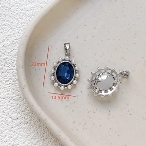 Macro view of 18k gold plated pendant with blue gemstone and pearls showing dimensions