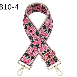 Close-up of bohemian embroidered wide shoulder strap with gold metal lobster clasps