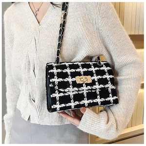 Classic black and white plaid tweed shoulder bag with gold chain and metal buckle