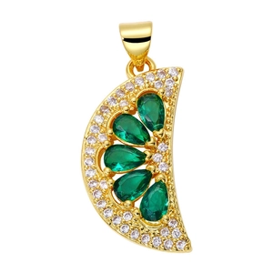 Macro shot of crescent pendant with emerald green teardrop stones and white zircon details