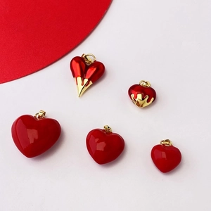 Red heart necklace pendants in various sizes with gold-melted edge detailing