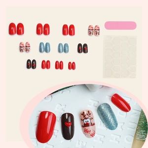 Christmas press-on nail set featuring reindeer designs and blue glitter with accessories
