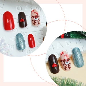 Christmas themed press-on nails set with red hearts, reindeer patterns and blue glitter