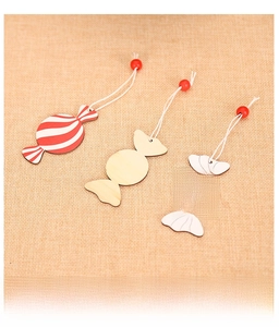 Detailed view of candy-shaped wooden ornaments with red stripes and natural wood texture