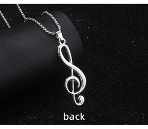 Macro back view of silver treble clef musical note pendant with stainless steel box chain