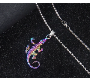 Macro shot of colorful metallic crocodile pendant on a silver box chain necklace