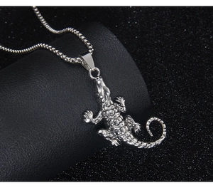 Detailed close-up of a silver crocodile pendant showing scales and metallic texture