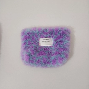Macro detail of plush purple and light blue leopard print makeup bag with texture