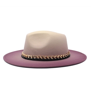 Detail of felt fedora hat featuring gradient beige to purple color and metal chain band